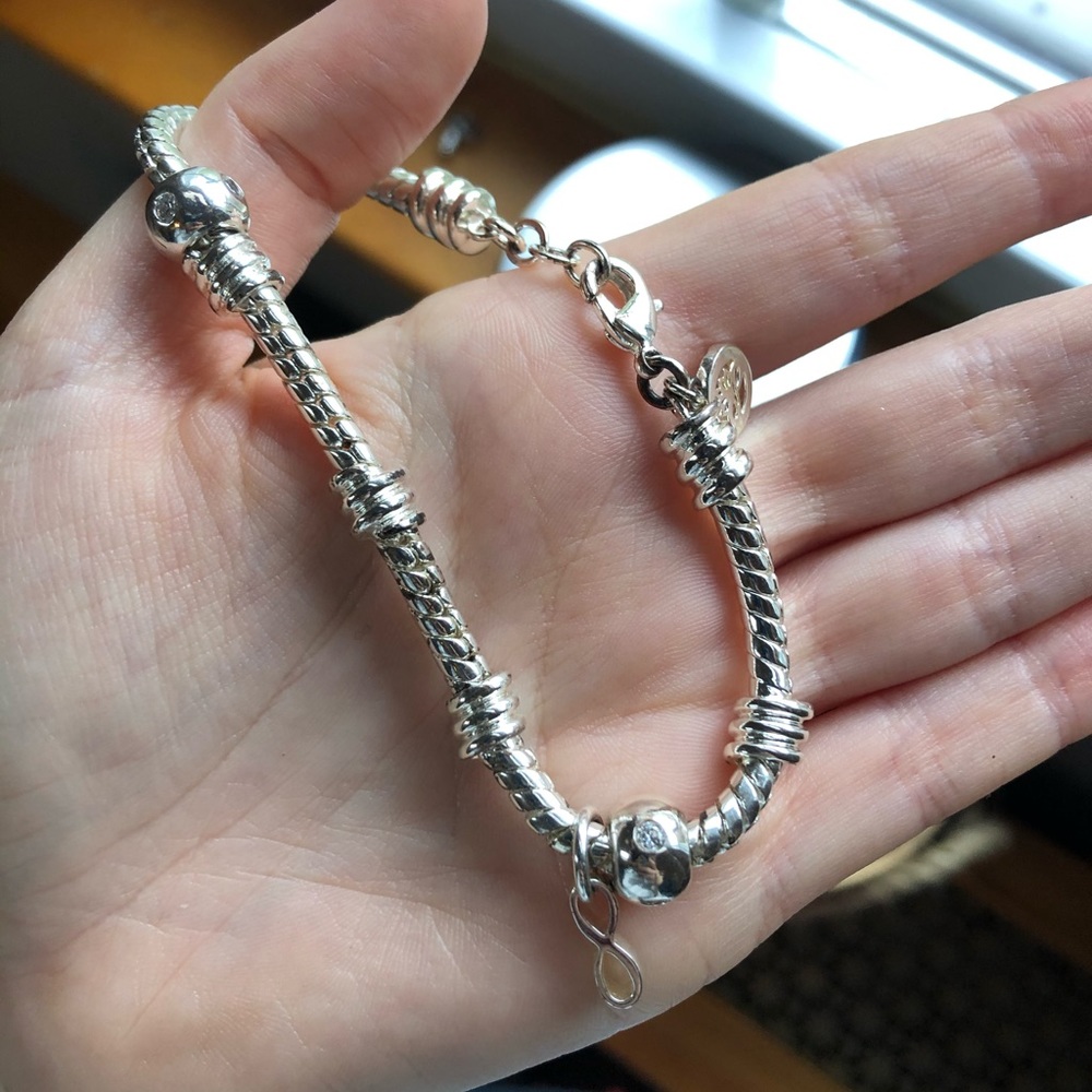 Gorgeous silver charm infinity bracelet. NWOT